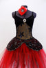 Black sequined, lace bodice accents romantic ballet tutu dress with crystal broach accent. Skirt is layers of black and red tulle.Has red floral hair accessory.Front Zoom