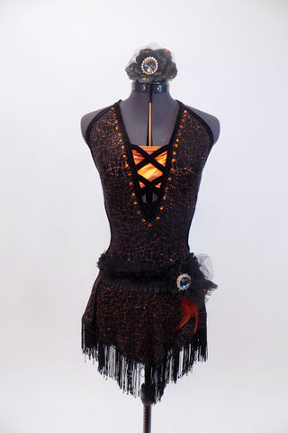 Halter neck dress has criss-cross straps & plunging front with orange bust panel, Has fringe skirt & belt with feathers, broach  & matching hair piece. Front