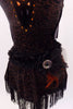 Halter neck dress has criss-cross straps & plunging front with orange bust panel, Has fringe skirt & belt with feathers, broach  & matching hair piece. Belt zoom      