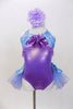 Lavender  and aqua leotard has tulle bustle skirt. Bodice is accented with lavender beads &  large purple sequined flower. Has is a large flower hair accessory. Front