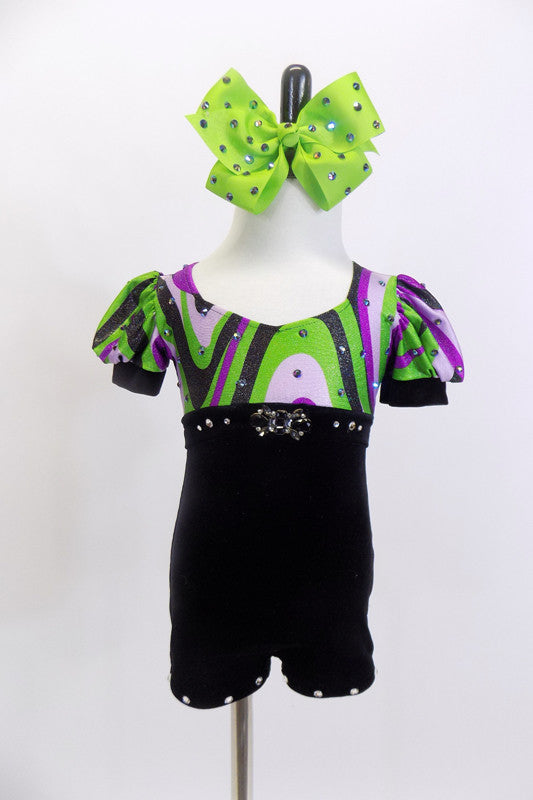 Child unitard has black velvet bottom & purple and green swirled bodice with crystal accent band.Has pouf sleeves,crystal accents & large green crystalled bow . Front