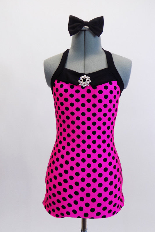 50s style bathing suit is polk-a dot and has boy short cut bottom, halter collar, broach accent and large matching bow hair accessory. Front