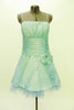 Mint green lined & boned taffeta Chicas mini dress has spaghetti straps and ruched bust area Wide pleated satin waistband has a large bow with crystal accents. Front