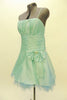Mint green lined & boned taffeta Chicas mini dress has spaghetti straps and ruched bust area Wide pleated satin waistband has a large bow with crystal accents. Side