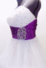White curly edge tulle boned dress has ruched purple satin waist band with large jewel accents. There is scattered amethyst Swarovski crystals throughout dress. Side Zoom