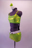 Lime green metallic two-piece costume is a camisole style tank top with princess cut. The matching bootie shorts has an attached white belt with silver oval buckle accent. Comes with a floral hair accessory. Side