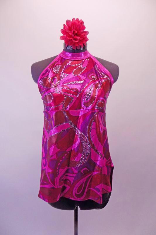 Pink purple and red 60s inspired high neck halter style A-line top has swirled design on a pink metallic base Comes with black shorts and matching hair accessory. Front