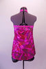 Pink purple and red 60s inspired high neck halter style A-line top has swirled design on a pink metallic base Comes with black shorts and matching hair accessory. Back