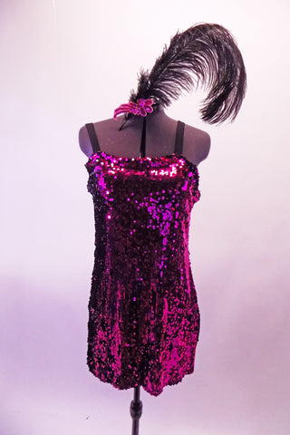 Magenta sequined slip dress with black wide shoulder straps is accompanied by a sequin applique and feather hair accessory. Front