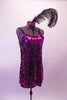 Magenta sequined slip dress with black wide shoulder straps is accompanied by a sequin applique and feather hair accessory. Side