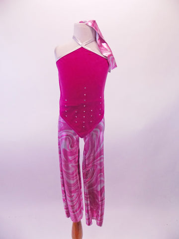 Pink and silver metallic swirl design Capri pants are accompanied by a fuchsia velvet top that has a halter neck, crystal accents and a front that comes to a point at the front torso top and bottom. Silver straps cross at the front neck and criss-cross at back for additional support. Front