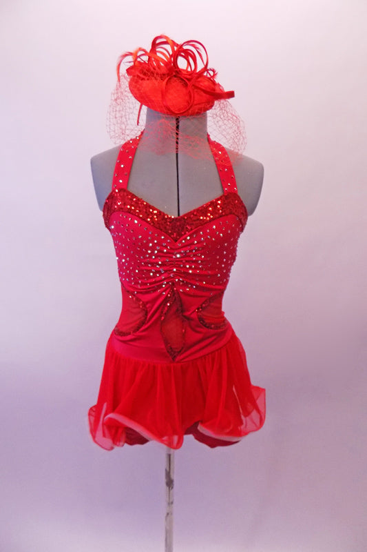 Red short dress has red sheer back, round cut sides and peek-a-boo center. The bust is gathered and covered with scattered crystals. All the banding is sequined red and the sheer red skirt and wide curly binding for large curled effect. Comes with red fascinator hat/headband accessory with a birdcage veil. Front