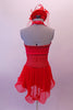 Red short dress has red sheer back, round cut sides and peek-a-boo center. The bust is gathered and covered with scattered crystals. All the banding is sequined red and the sheer red skirt and wide curly binding for large curled effect. Comes with red fascinator hat/headband accessory with a birdcage veil. Back