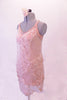 Blush camisole leotard dress has racer style back and a sheer lace overlay. The overlay is comprised of sections of seer lace, French floral lace, polka dot lace and lace rosettes. Comes with a blush chiffon floral accessory. Left side