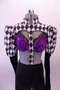 3-piece costume has a purple sequined bra (34B), with crystals, double back band & black ruffle. The black and white harlequin shrug has a mandarin collar and pouffe sleeve that is black from elbow down. There is a center strap that extends down the center of the torso to the waist of black leggings. Front zoomed