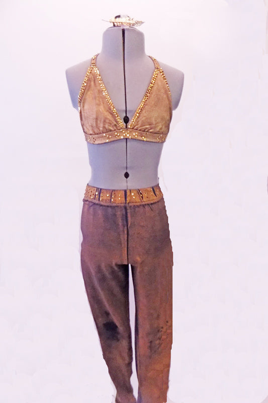 Two-piece costume has a stretch denim base with a gold over-dye. The halter-neck triangle bra is edged completely with amber crystals. The matching jegging has a crystalled waistband. Comes with a gold hair accessory. Front