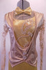 Gold leotard has sheer beaded ivory appliqued lace long sleeves. The bust and neck ate also covered with the appliqued lace and sits below a lighter gold attached tailcoat vest with large crystal buttons Comes with a gold bow tie. Front zoomed