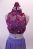 Periwinkle finely pleated chiffon, knee-length high-low skirt has a wide waistband. The high neck half-top has a periwinkle base with a purple sheer that is adorned with sild roses in shades of pinks, purples and deep berry. Comes with deep berry coloured floral hair accessory. Front zoomed