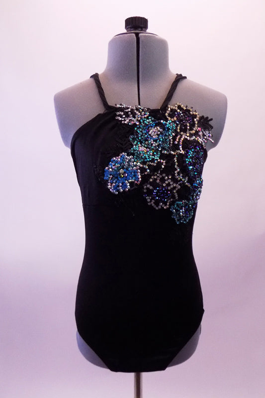 Black leotard has a halter style neckline with a braided cord that unravels to become tree back straps on either side forming a criss-cross pattern along the low open back. Along the front left & side is a gorgeous large beaded, sequined & fully crystalled applique of cascading flowers in shades of blues & greens. Front