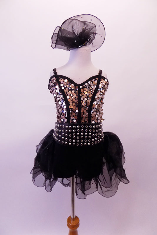 Black & gold costume has a gold, large circle sequined bodice with black princess cut piping. The back of the top is open with thin double black bands beneath the band The curly hemmed sheer black bustle skirt has crystals & is open at the front & poufy at the back. Comes with wide gold studded elastic belt & hair clip. Front
