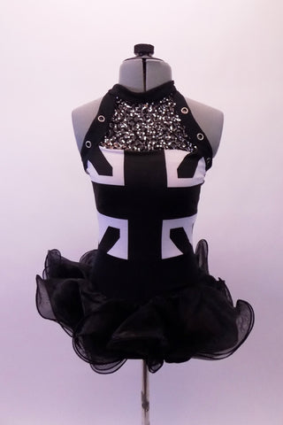 Black and white costume has a halter style front with a black monochrome Union Jack. The upper bust is fully sequined and edged with black grommeted banding. The curly-hem organza skirt portion has attached shorts. Front