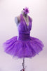 Purple tutu has more contemporary styling with a halter overlay neck on the camisole bodice with large crystal Brooch accent. The wide gathered cummerbund waistband, front -halter & skirt of the dress are sheer poly-chiffon with streaks of silver dot veining. The back of the bodice is pale lavender. Side