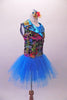 Colourful costume has a turquoise tulle skirt with rainbow sequin waistband, attached to a turquoise short unitard base. The brightly coloured graffiti-style vest has shiny blue lapels with wide rainbow sequin accent. Comes with matching gauntlets and hair accessory. Right side