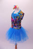 Colourful costume has a turquoise tulle skirt with rainbow sequin waistband, attached to a turquoise short unitard base. The brightly coloured graffiti-style vest has shiny blue lapels with wide rainbow sequin accent. Comes with matching gauntlets and hair accessory. Left side