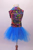 Colourful costume has a turquoise tulle skirt with rainbow sequin waistband, attached to a turquoise short unitard base. The brightly coloured graffiti-style vest has shiny blue lapels with wide rainbow sequin accent. Comes with matching gauntlets and hair accessory. Back