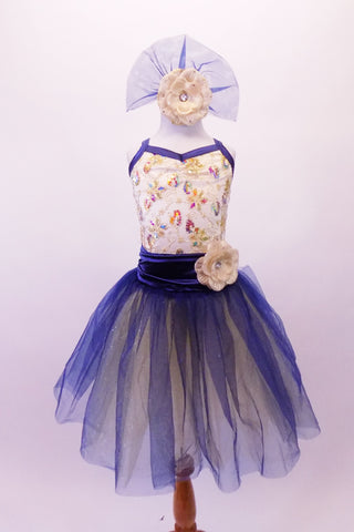 Pretty romantic tutu has a cream-based bodice with gold sequined lace overlay. The deep blue trim and cross straps match the long crystal blue and cream romantic tutu with wide cummerbund waistband. Comes with matching floral hair accessory. Front