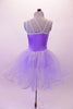 Lavender romantic tutu has a glitter tulle skirt with large curly hem. The bodice has gold and purple sequined accents with a single right and triple left shoulder strap that form a unique angle at the back. There is a large lavender flower accent at the right shoulder and left hip. Comes with a gold hair barrette. Back