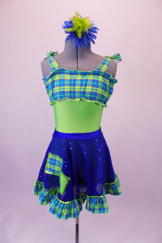 Fun lime green-based leotard has blue-green plaid blouson-style bust area that ties at the shoulders. The matching blue sequined pull-on skirt has plaid ruffle edge and faux decorator pockets. Comes with a floral hair accessory. Front