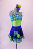 Fun lime green-based leotard has blue-green plaid blouson-style bust area that ties at the shoulders. The matching blue sequined pull-on skirt has plaid ruffle edge and faux decorator pockets. Comes with a floral hair accessory. Right side