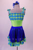Fun lime green-based leotard has blue-green plaid blouson-style bust area that ties at the shoulders. The matching blue sequined pull-on skirt has plaid ruffle edge and faux decorator pockets. Comes with a floral hair accessory. Back
