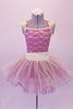 Romantic tutu dress is a cream base with sequined magenta lace overlay. The cream piping and gathered cummerbund waist complement the soft flowers at the shoulders. A cream curly hemmed cream overlay rest over the top of the magenta tulle skirt. Comes with a cream floral hair accessory. Front