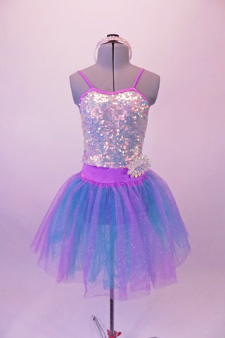 Beautiful romantic tutu dress has silver sequined camisole bodice with lilac piping, A blue and lilac crystal tulle skirt is attached at the waist by a lilac waistband with jeweled accents. Comes with a jewelled headband. Front