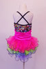 Rainbow sequined camisole tank dress has black cross straps. The curly ruffled skirt is layers of bright pink, blue and green with a black edge. There is an organza rose at the left bust. Comes with a pink floral hair accessory. Back