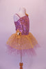 Gold and lavender tutu dress has a single shoulder with a single strap. The bodice is a marble of lavender and gold covered in sequins. The lavender tulle, knee-length skirt, has a gold sequined overlay. Gold sequined flowers accent the left shoulder and right hip. Side
