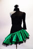 Dress has a black torso with a single shoulder and long left pouffe sleeve, attached to a neckband collar. The entire torso is covered with SS20 black crystals and is angled down towards the right hip. The emerald satin skirt had layered black ruffled petticoat for added volume. Comes with a hair accessory. Front