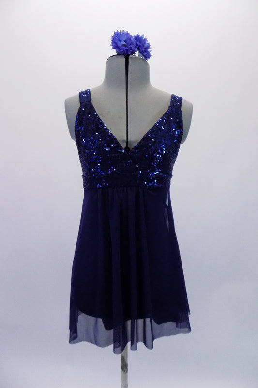 Navy blue empire cut baby-doll dress had a sequined bust and flowing knee-length chiffon shirt. The dress has an attached brief and comes with a floral hair accessory. Front