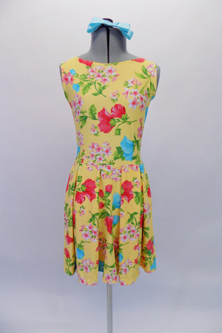 Yellow, tank style, stretch dress with turquoise and coral large floral print has a partially pleated full circle skirt that flows beautifully on stage. Comes with matching turquoise satin bow hair accessory. Front