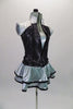 Three-piece, silver costume is comprised of a camisole leotard with a matching short double ruffled skirt with black piping. The accompanying zip front vest is a sequin print black with silver quilted shoulders. Comes with a hair accessory. Side
