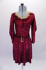 Burgundy crushed velvet, A-line tunic dress has glitter floral detail in the fabric and gold sequined braid that sits along the neckline. The ¾ angel-sleeve gives the dress a medieval look. Comes with tie belt and hair accessory. Front