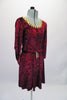 Burgundy crushed velvet, A-line tunic dress has glitter floral detail in the fabric and gold sequined braid that sits along the neckline. The ¾ angel-sleeve gives the dress a medieval look. Comes with tie belt and hair accessory. Side
