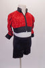 Bright red sequined crop cut jacket has black banding, and ¾ gathered sleeves. Matching black shorts accompany the jacket. Side