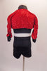 Bright red sequined crop cut jacket has black banding, and ¾ gathered sleeves. Matching black shorts accompany the jacket. Back