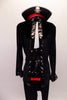Fun, pirate-themed costume has a tunic style, long-sleeved, high collar top that zips at the back. The front has a leather-like panel as do the cuffs, with metal button accents. Black leggings complement the tunic top. A large pirate hat with skull and crossbones completes the look. Front zoomed