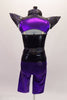 Black camisole top has a nude mesh insert with crystal accent and sequined belt. A purple metallic and sequined short shrug sits over top with pointy cone shoulders and chains. Matching purple knee-length pants accompany the top. Comes with a unique purple and black mask.  Back