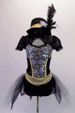 Black lace leotard has a high collar, pouffe sleeves & open back. The bodice has a peek-a-boo front opening &is  adorned with a silver jewelled steampunk pattern. The attached black & grey, open front tulle bustle skirt has scattered crystals. Comes with gold accented black felt bucket hat with a black ostrich feather. Front