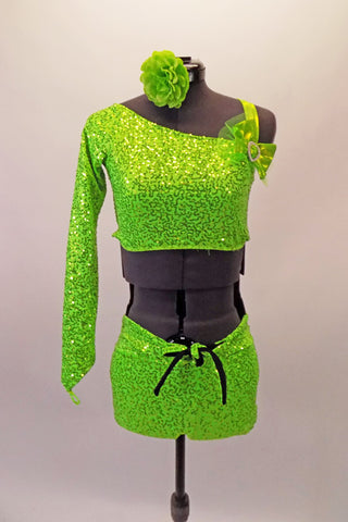 This two-piece neon lime green costume comes with an angled, single shoulder half top has a jewelled bow accent at the left bust below the shoulder strap. The back is comprised entirely of a series of crossing 1” straps. The bottom is sequined shorts with front knot tie accent. Comes with matching hair accessory. Front